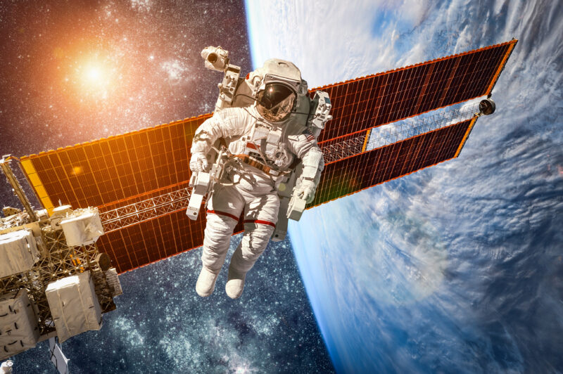 International Space Station and astronaut in outer space over planet Earth provided by NASA