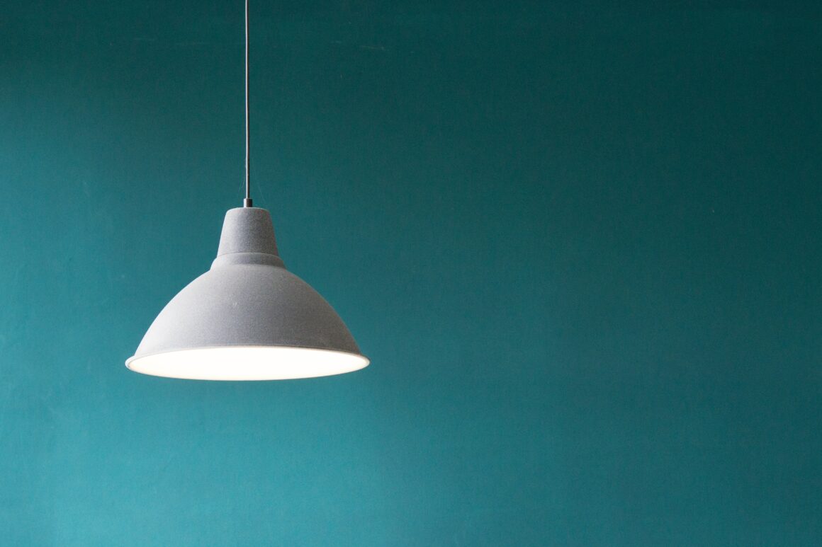 White hanging light fixture on a blue background