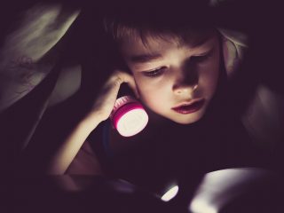 Small child using a sleeping light before bed