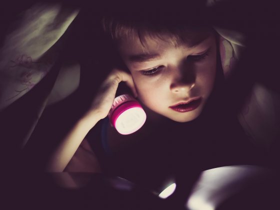 Small child using a sleeping light before bed